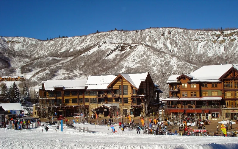 Capitol Peak Lodge backing onto Assay Hill in Snowmass Base Village, ski-in walk-out lodging at Aspen Snowmass, Colorado
